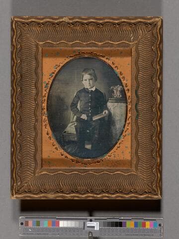John B. Wilson as a young boy, holding a book