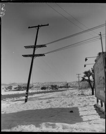 Distribution pole leaning to one side in snow
