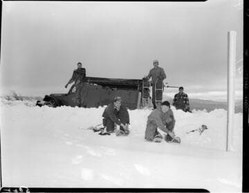 Linemen walking to distribution pole with snow shoes