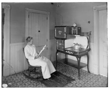 West Auto, Electric Range [with woman sitting in kitchen reading]
