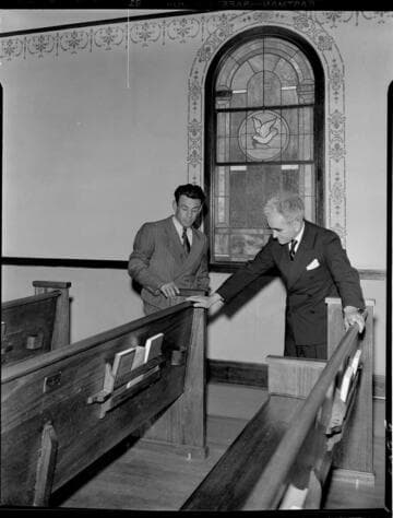 Augustine Rambeau and Romona Cobera inspecting church pews