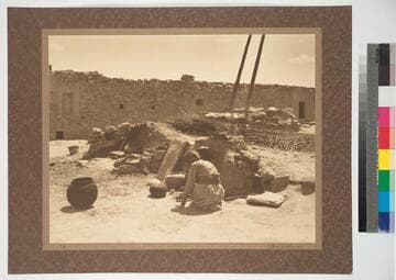 Nampeyo, the artist-potter of the Hopi people, arranging pottery for firing, Hano, First Mesa, Arizona