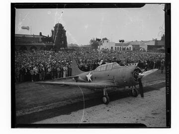 World War II-era warplane at L.A. Municipal Airport with barrage balloon