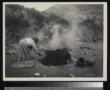 Papago Indian woman using oven for pottery.  Near Bisbee, Arizona