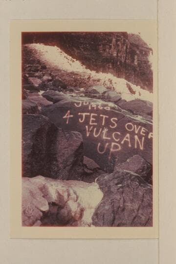 Sign painted on the rocks at the edge of Vulcan Rapid after the four jet boats topped it 1960, July 06.  Dupe slide made by a member of the White party
