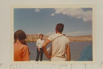 Helen Rowland greets the deck boat party at the dock at Temple Bar Wash