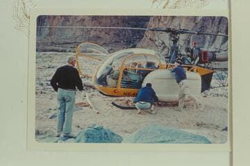 Dock Marston checks the Yak lashing to the helicopter as the pilot checks the whole operation.  217 Mile Rapid