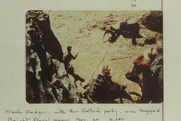 Upset at Mile 232.5.  Duane Bishop leaping off rock, Frank Wright pulling and Lucy Arnold and Pat McCormick watching