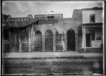 Exterior of photographer's studio, with signs in English and Chinese