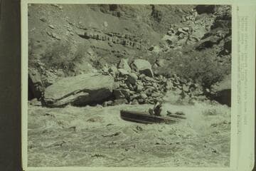 Marston piloting inboard motorboat through Hance Rapid