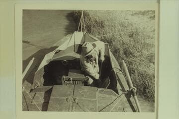 Dock Marston pumps the bilge of the "Esmeralda II";  foot of Tanner Trail