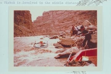 Dock Marston lines a Yak in Dark Canyon Rapid.  Jorgen Visbak is involved in the middle distance