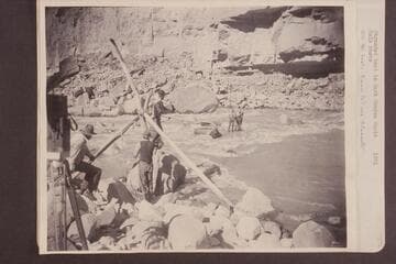 Stranded boat in Dark Canyon Rapid.  On the boat:  Emery (left) and Ellsworth