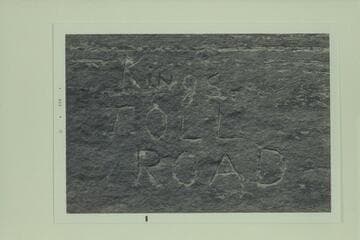 Inscription, "Kings Toll Road" on boulder near road at about Mile 85.  Colorado River above Moab