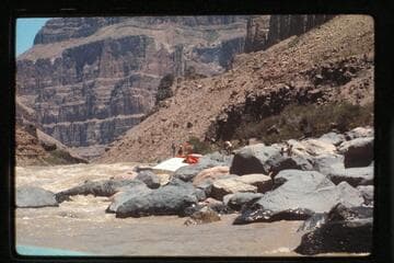 "Wee Red" on rocks; Vulcan Rapids