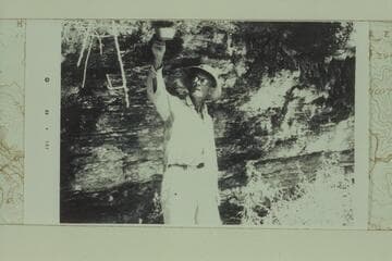Louis West gathers a few drops of water from a spring in the right hand or main fork of Separation Canyon