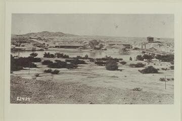 Yuma, Arizona, from Fort Yuma.  The steamer appears to be the "Gila" and the long buildings left of center are the warehouses of the steamship company