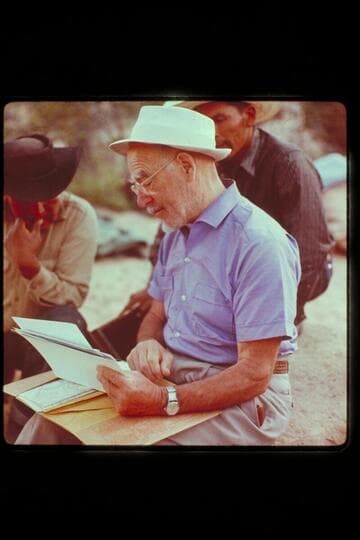 Dock shows maps and pictures to Dan and Bale[?]; Surprise Valley