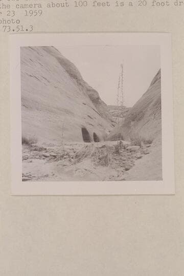 Up the water course of the southwest fork of 73.  There are two small drops just beyond the holes in the wall.  Back of the camera about 100 ft. is a 20-ft. drop
