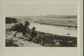 Sarah Fraser on the rim above the wreck of the Stone-Stanton dredge in Glen Canyon above Hansen Creek