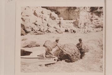 Nevills and Joe Desloge work the bow line around a rock