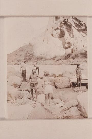 Portage of Nevills boats at Lava Falls.Above and to left is John Riffey, Custodian of Grand Canyon National Monument.Kent Frost works the lines in the distance.Garth Marston is at right.In foreground Nevills explains portage to Margaret Marston