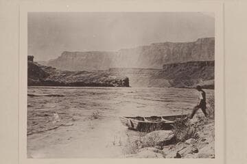 Jerry Johnson stepping into a skiff to cross the river for the mail, Lees Ferry