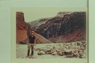 Chuck Warren standing on shore at Hance Rapid