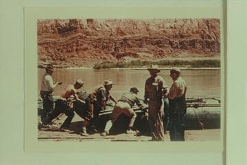 Launching the neoprene craft of the Hatch-Dines trip in 1954.  Walt Emery; Tyson Dines; Allan Smith; Jim Nelson; Smuss Allen; and Bus Hatch.  Lees Ferry