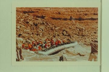 Georgie White's tribe on her boloneys plopping through Soap Creek Rapid.  Ballard Atherton photographs the act from the left