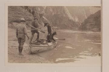 Wrangler and dudes stepping aboard the Pathe-Bray skiff "Bright Angel" for a swing around the eddy at Bright Angel Creek