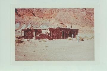 Dock Marston reads sign in front of fort at Lees Ferry