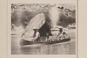 Doris Nevills riding as passenger in the canoe with Bishop W. R. McConkie and Wayne McConkie in Cataract Canyon below The Junction