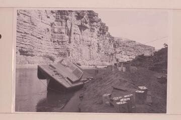 The twin jet "Little Squirt" rolled on the bank at Mile 4 for repair.  After temporary patching the party returned to Lees Ferry and abandoned the trip until June 18 when a complete run of the Canyon was made.  This boat became known as the "Big Red."
