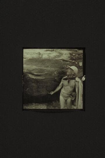 Marston standing on ledge and examining the inscription where Frank Mason Brown was drowned in 1889.  Mile 12, Marble Canyon