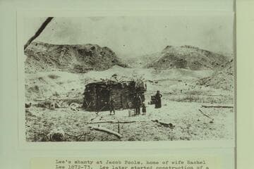 Lee's Shanty at Jacob Pools, home of wife Rachel Lee 1872-1873.  Lee later started construction of a rock house at this location but it was never finished.  People in photo probably J. D. and Rachel Lee
