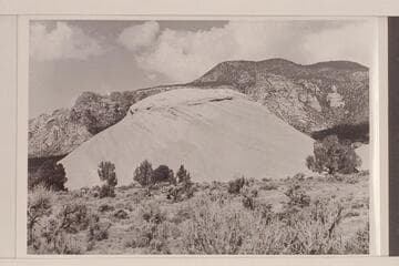 Small sandstone butte and Navajo Mountain