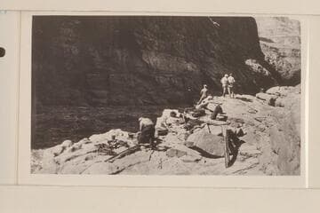 The two tons of supplies on the rocks at lower end of Lava Escarpment Rapids, the supplies having been carried around are now ready to be loaded in the boats.  L to R:  Koms, Blake, Lint, Stabler and Birdseye