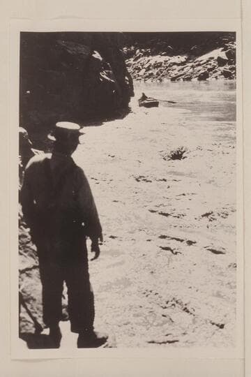 Lining boats past cliffs at head of Lava Cliff Rapids; Koms
