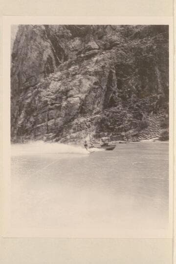 Cooper skiing on Lake Mead in Grand Canyon.  One of the outboard boats nearby