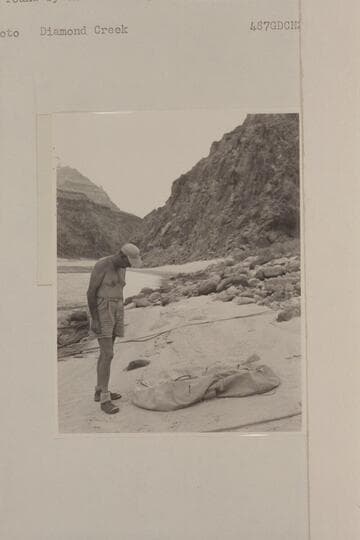 John Doerr examines the life raft lost by the Scout Troop in Glen Canyon and found by the Nevills party at Mile 219 in Grand Canyon.  Diamond Creek