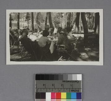 Edwin Powell Hubble and Grace Burke Hubble sitting at a table outdoors on a camping trip