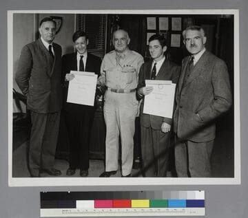 Edwin Powell Hubble, Franklin V. Reno, Major General Harris, Thomas D. Carr and an unidentified man, with Reno and Carr holding certificates of recognition from the U.S. War Department