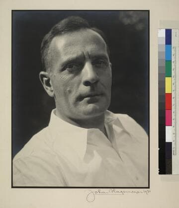 Studio portrait of Edwin Powell Hubble in a white shirt