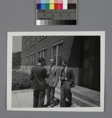 Edwin Powell Hubble and two unidentified men outside a building at the U.S. Army Ballistic Research Laboratory
