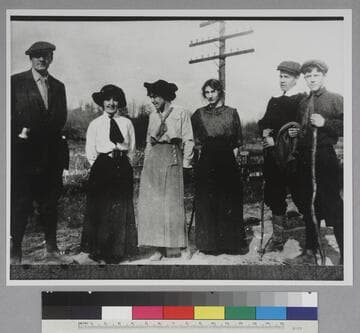 Edwin Powell Hubble and five unidentified companions, standing outside