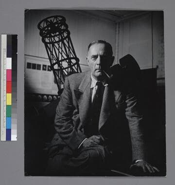 Edwin Powell Hubble in front of an astronomy exhibit