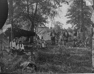 Temporary Cheyenne camp during Grand Council meeting, 1875. At left, interpreter Philip McClusker and his Cheyenne Indian wife, Minnehaha