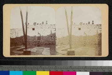 Children look over a wall at Acoma Pueblo