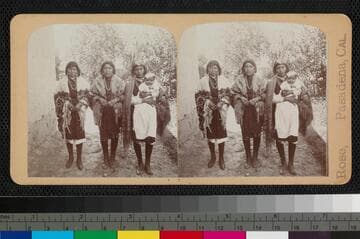 Three Pueblo Indian women, one holding a baby